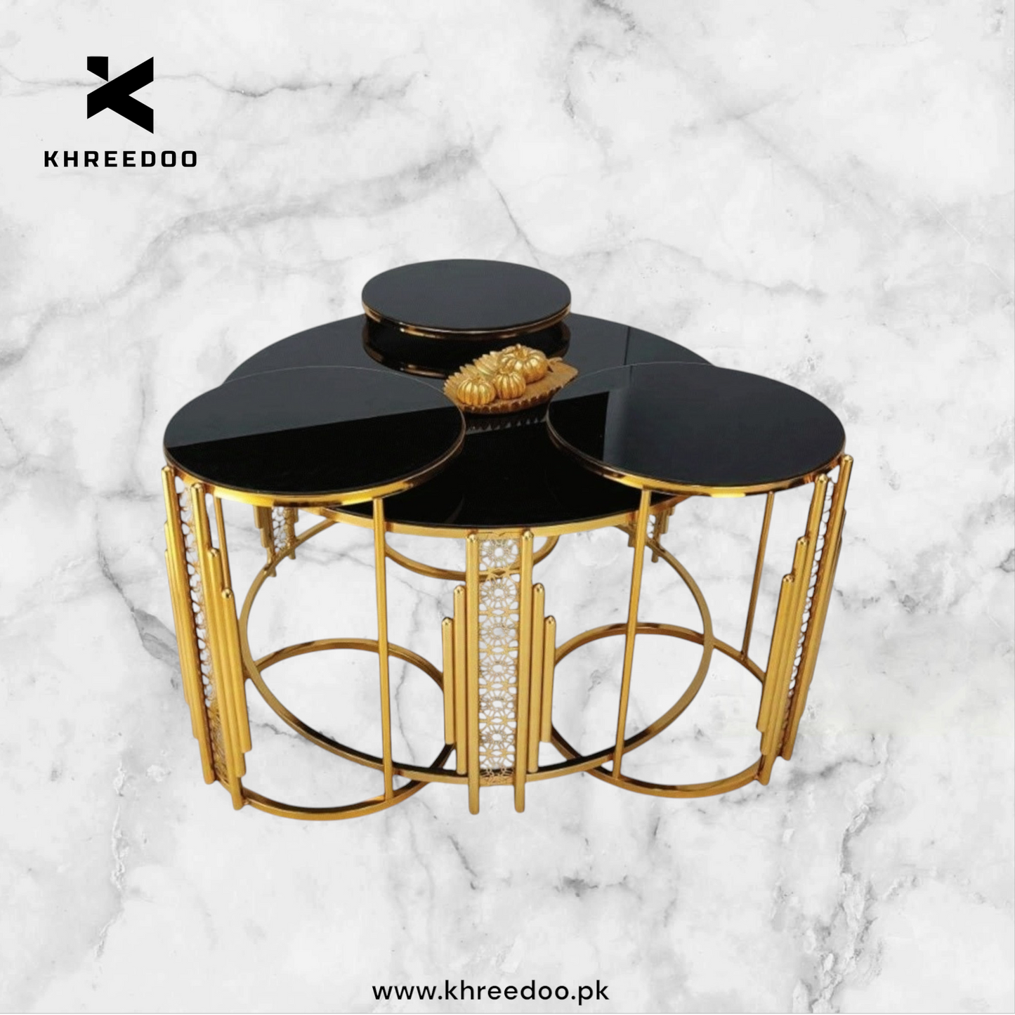 A set of round nesting tables with a gold metallic frame and high-gloss black glass top, with a decorative gold flower on the center table.
