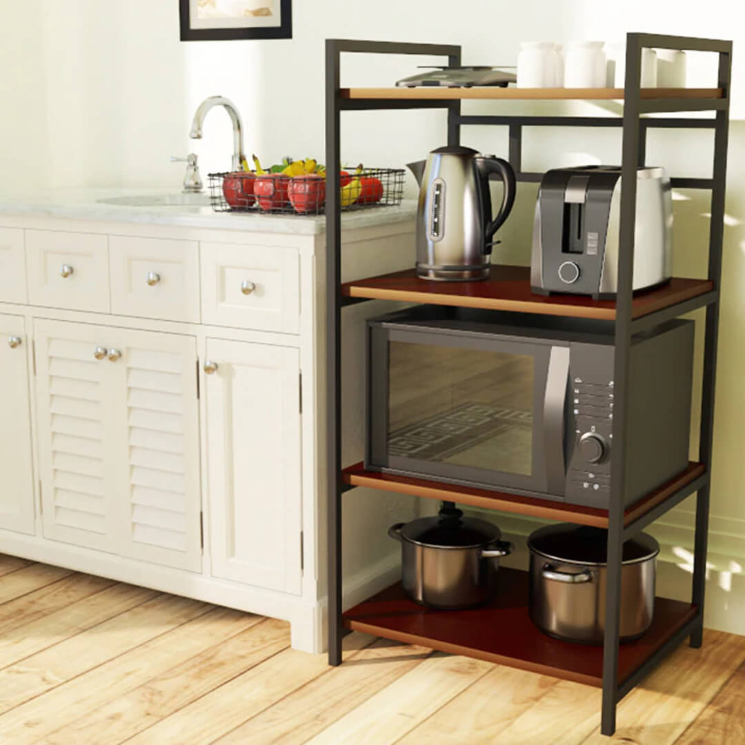 A contemporary kitchen storage rack with multiple shelves, holding a microwave oven and various kitchen items like bottles and a pressure cooker.