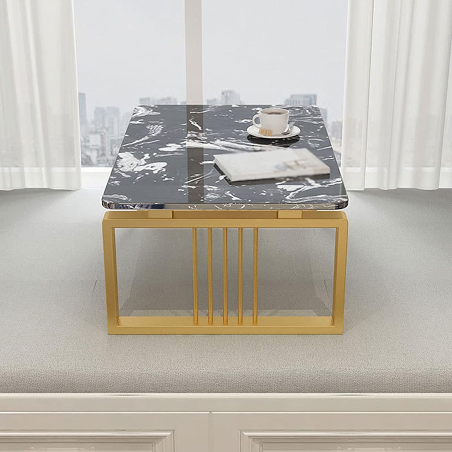 A rectangular coffee table with a marble design on the top and a gold-colored metal frame.
