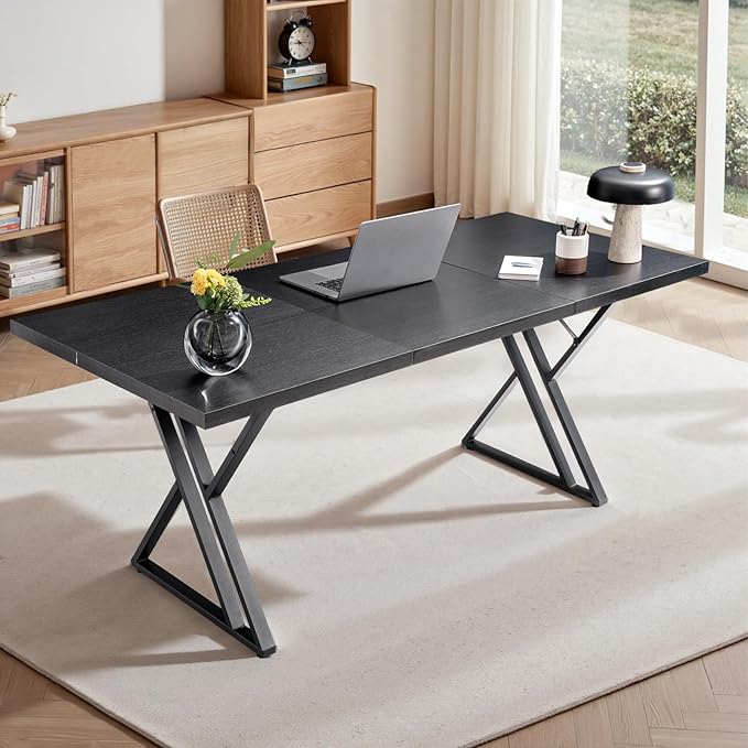 Modern office desk with laptop, decor items, and a chair in a bright room.