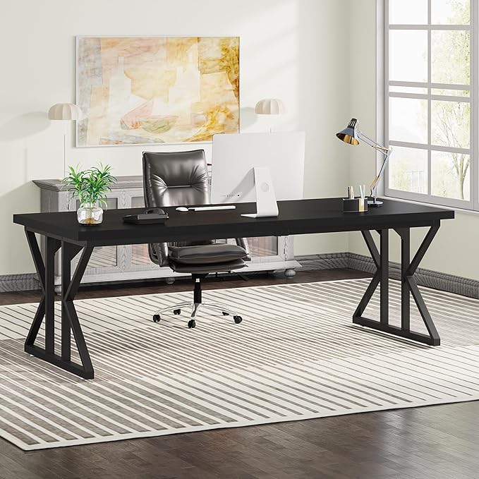 Modern office setup with a black desk, chair, and decor elements.