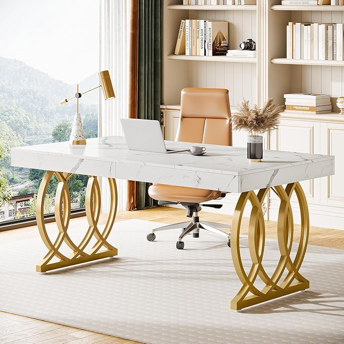 Modern office desk with marble surface and gold legs in a bright room.