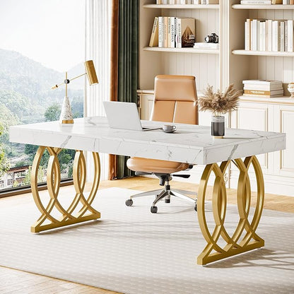 Modern office desk with marble surface and gold legs in a bright room.