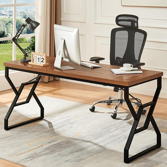 Wooden desk with office chair, computer monitor, and lamp in a home office setting.