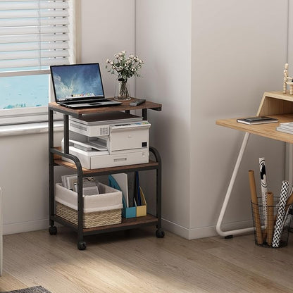 Small office desk with a laptop, printer, and various items in a room with a window.