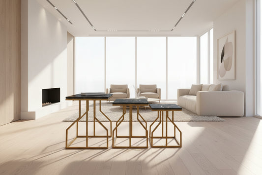 Three black marble tables with gold metal frames on a pink mat outdoors.