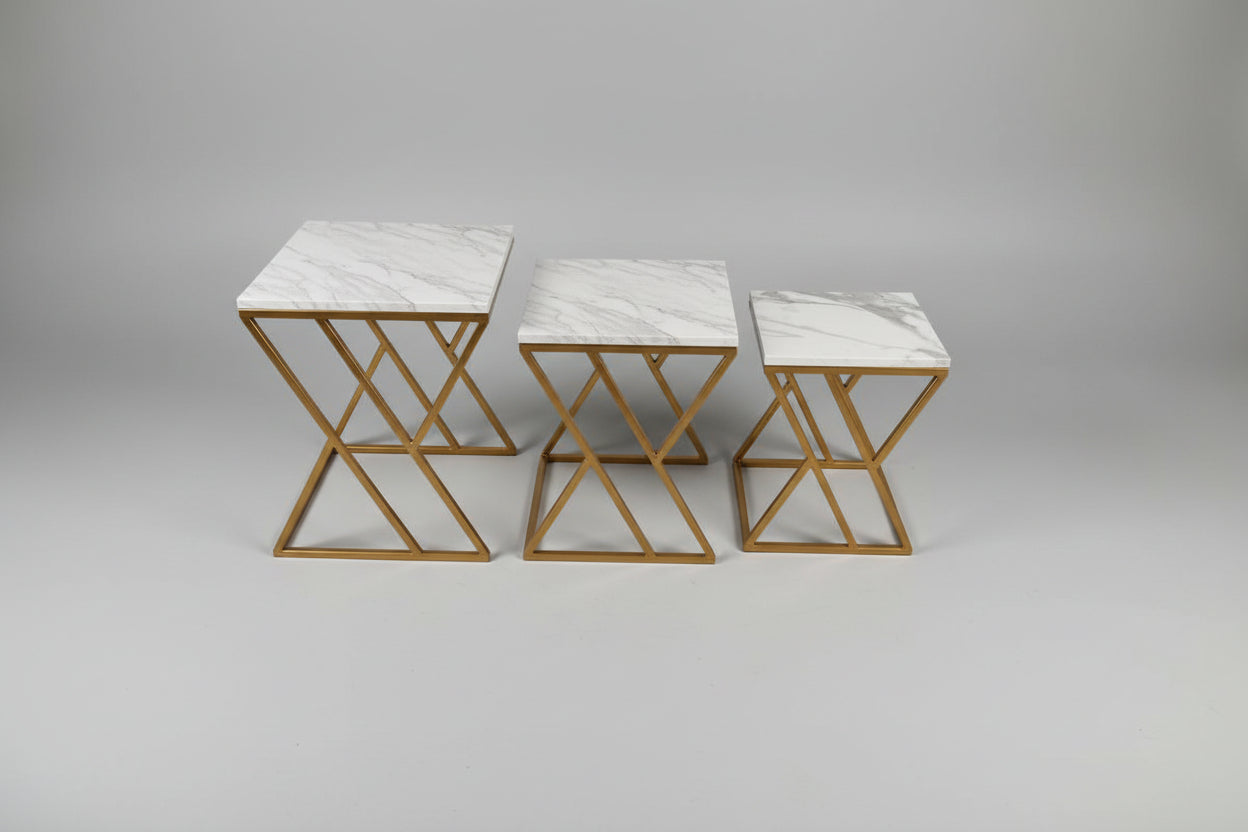 Three marble top tables with gold metal frames on a pink mat.