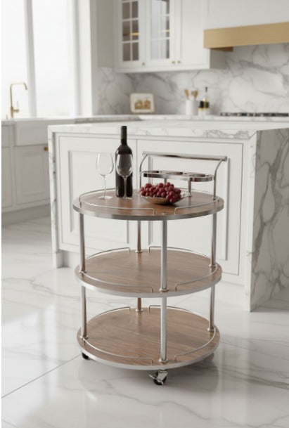 Three-tiered wooden serving cart in a kitchen setting with a marble countertop.