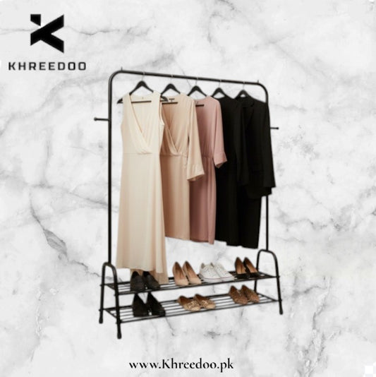 Clothing rack with dresses and shoes on a marble background, featuring the Khreedoo brand.
