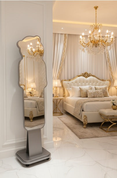 Luxurious bedroom with a standing mirror, bed, and chandelier.